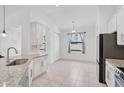 Bright and open kitchen with stainless steel appliances, granite countertops, and ample cabinet space at 12014 Creek Preserve Dr, Riverview, FL 33579