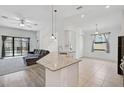 Open-concept living room with a large sectional sofa, tile floors, and sliding glass doors to the pool area at 12014 Creek Preserve Dr, Riverview, FL 33579