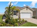 Charming single-story home featuring a well-manicured lawn and a two-car garage with brick paved drive at 12538 Somatic Ct, Venice, FL 34293