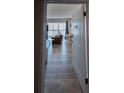 Open doorway to a stylish living room with ample seating, light wood flooring and a dining area at 1255 Tarpon Center Dr # 604, Venice, FL 34285