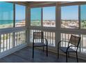 Cozy sun room with chairs and a beautiful view of the surrounding area at 1255 Tarpon Center Dr # 604, Venice, FL 34285