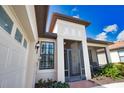 An inviting front entrance with a decorative metal gate and a charming side porch at 1438 Maseno Dr, Venice, FL 34292