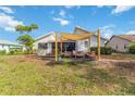 Inviting backyard patio with comfortable seating beneath a modern shade structure and a view of the home at 1439 Strada D Argento, Venice, FL 34292