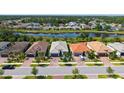Aerial view of a well-maintained property in a lovely neighborhood with lush greenery at 1481 Hyssop Loop, North Port, FL 34289