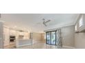 Open-concept living space with stainless appliances and outdoor views through sliding glass doors at 1481 Hyssop Loop, North Port, FL 34289