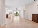 Bright and open living room featuring tile flooring, neutral paint, and sliding glass doors at 1493 Maseno Dr, Venice, FL 34292