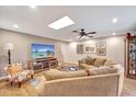 Inviting living room with a comfortable sofa, large TV, and ample natural light at 1515 Pecan St, Nokomis, FL 34275