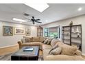Spacious living room with a large sectional sofa, bay window, and stylish decor at 1515 Pecan St, Nokomis, FL 34275