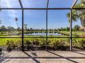 Screened lanai offering tranquil views of the lake and meticulously maintained green space at 165 Tiziano Way, North Venice, FL 34275