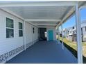 Wide, covered carport offering ample parking and protection from the elements at 202 Mantua Dr, Venice, FL 34285