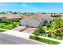 Charming home featuring a tile roof, lush landscaping, and a three-car garage at 21649 Avon Park Ct, Venice, FL 34293