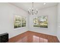Bright dining room with hardwood floors, chandelier, and large window at 233 Cape Harbour Loop # 107, Bradenton, FL 34212