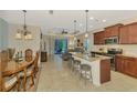 Open-concept kitchen with granite countertops, stainless steel appliances, and a center island at 241 Marcheno Way, Nokomis, FL 34275