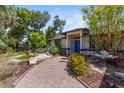Inviting walkway leading to a front door framed by lush landscaping and stone accents at 2424 Affinity Ln, North Port, FL 34286