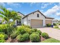 A lovely home with a two-car garage, brick paved driveway, and well maintained landscaping at 27467 Janzen Ct, Englewood, FL 34223