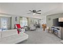 Spacious living room with modern furniture, a ceiling fan, and an open layout at 318 Venice East Blvd, Venice, FL 34293
