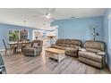 Cozy living room featuring hardwood floors, comfortable leather seating, and a bright open floor plan at 352 Glenwood Ave, Osprey, FL 34229