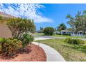 Sidewalk view of the well manicured lawn, garden and neighborhood street at 3851 Sterling Rd, Venice, FL 34293