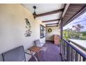 A cozy outdoor balcony with seating and a view of the surrounding green landscape at 410 Mission E Trl # B, Venice, FL 34285