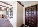 Exterior shot of condo entrance featuring a decorative window, unique lighting, and a dark brown door at 410 Mission E Trl # B, Venice, FL 34285