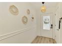 Bright foyer features stylish mirrors and a pendant light fixture that complements the front door at 4321 Shamrock Dr, Venice, FL 34293