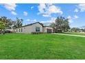 Well-maintained home with a lush green lawn and a view of the neighborhood at 4390 Asteria Ter, North Port, FL 34287