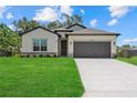Charming single-Gathering home with a manicured lawn and attached two-car garage at 4390 Asteria Ter, North Port, FL 34287