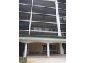 Entrance to a building that has benches and a covered area and dark tinted windows at 512 W Venice Ave # 205, Venice, FL 34285