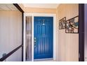 Beautiful blue front door with decorative accents and a sidelight for added brightness at 552 Bellaire Dr, Venice, FL 34293