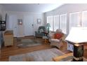 Bright living room featuring hardwood floors, white walls, and large windows with natural light at 554 Aspen Ave, Venice, FL 34285