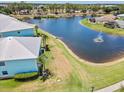 Peaceful aerial view overlooking a tranquil lake with a fountain, surrounded by well-kept lawns at 5739 Sabal Trace Dr # 102, North Port, FL 34287