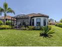 The house has a spacious backyard, with a screened-in lanai and a mature palm tree at 5853 Semolino St, Nokomis, FL 34275