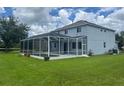Backyard featuring a screened-in porch, a pool, and a well-manicured lawn at 5966 Willows Bridge Loop, Ellenton, FL 34222