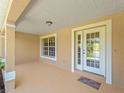 Covered entryway with double doors and a small porch area, perfect for welcoming guests at 6199 Stamp St, Port Charlotte, FL 33981
