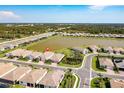 A wide aerial shot shows the home's location within the community, near the lake and lush landscaping at 629 Ibiza Loop, Venice, FL 34292