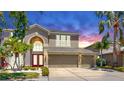 Elegant two-story home with a three car garage and well manicured lawn at 632 Tanana Fall Dr, Ruskin, FL 33570