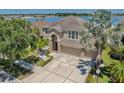 Stunning two-story home with well-maintained landscaping and a three-car garage, located near a lake at 632 Tanana Fall Dr, Ruskin, FL 33570