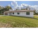 Well-maintained home featuring a neat lawn, an attached garage, and a freshly painted exterior at 6497 Honeycomb Cir, North Port, FL 34291