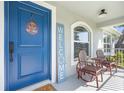 Inviting front porch with seating area and welcome sign, enhancing the home's appeal at 755 Mohawk Rd, Venice, FL 34293