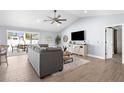 Bright living room with vaulted ceiling, sliding glass doors to lanai, and barn door at 755 Mohawk Rd, Venice, FL 34293