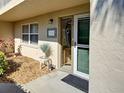 Charming condo entrance with lush landscaping and decorative welcome sign adding curb appeal at 821 Waterside Dr # 106, Venice, FL 34285