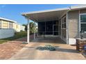 Covered carport with painted turtle art and a bicycle parked, providing shaded parking and outdoor space at 902 Jolanda Cir, Venice, FL 34285