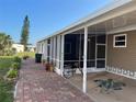 Side view of a carport featuring decorative lattice work and a turtle art design, with room to park at 902 Jolanda Cir, Venice, FL 34285