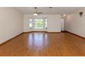 Bright living room with hardwood floors and a large bay window offering plenty of natural light at 976 Euclid Rd, Venice, FL 34293