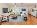 Bright living room with hardwood floors, bay window, and modern decor at 976 Euclid Rd, Venice, FL 34293