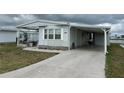 Cozy single-story home with a carport and well-manicured landscaping at 103 Lakeview Dr, North Port, FL 34287