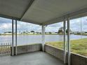 Serene view from the patio overlooking a tranquil lake and surrounding community at 103 Lakeview Dr, North Port, FL 34287