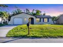 Inviting single-Gathering home with a manicured lawn, lovely blue shutters, and a convenient mailbox at 1032 Elaine St, Venice, FL 34285