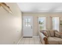 Bright entryway featuring neutral tones, tile floors, and decorative glass front door at 10444 Willmington Blvd, Englewood, FL 34224