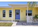 Inviting front entrance with a blue door, seahorse detail, and decorative touches at 10444 Willmington Blvd, Englewood, FL 34224